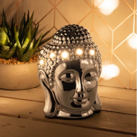A buddha inspired Aroma Wax Burner with a warm glowing LED Centre and sleek chrome inspired tone 