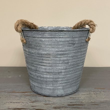 A large decorative zinc planter set with a white wash tone and ridge embossment 