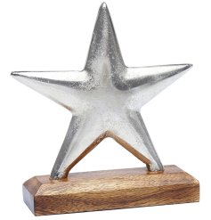 A aluminium silver metal star decoration on a contrasting chunky wooden base.