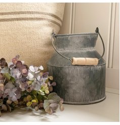 Set with an overly distressed coating, a small zinc churn sure to place perfectly in any home space with a similar theme