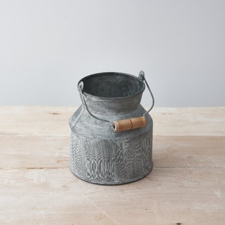 a small decorative zinc churn sure to place perfectly in any home space with a similar theme 