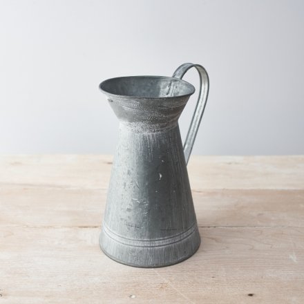 Part of a range of Rustic Charm themed accessories, a tall decorative metal vase with an overly distressed setting and s