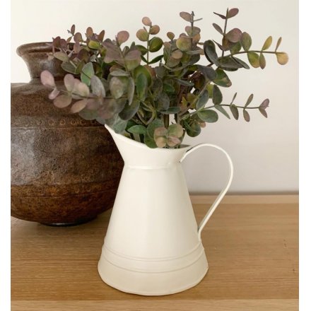 A simplistic decorative metal jug set with a ridged decal and matte cream tone, perfect for filling with artificial bloo