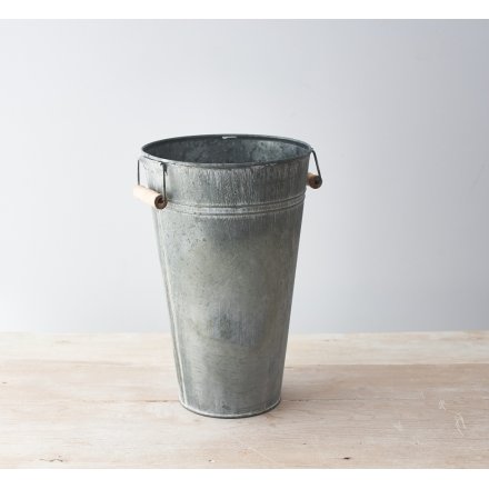   Part of a range of Rustic Charm themed accessories, a tall decorative metal vase with an overly distressed setting and