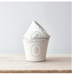 Perfect for bringing a vintage charm to any home space, a sleek white toned glazed pot with a pretty fleur de lis emboss