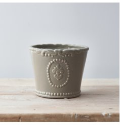 Perfect for bringing a vintage charm to any home space, a grey toned glazed pot with a pretty fleur de lis embossment 