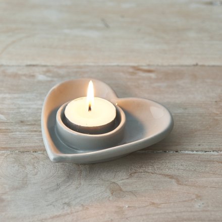 A charmingly simple heart shaped ceramic dish featuring a T-light holder space 