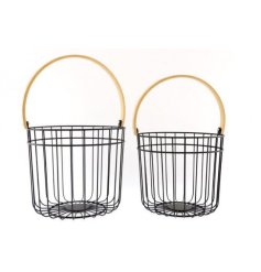 An assorted sized set of black wire carry baskets with chunky bamboo based handles 