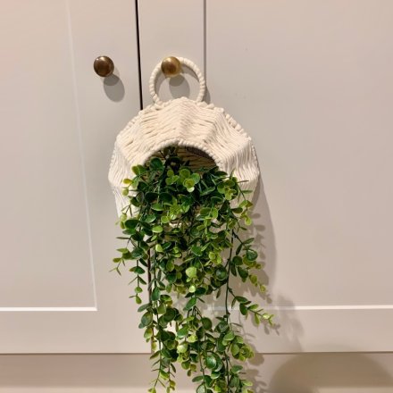 A simple yet chic hanging woven basket with an artificial draping eucalyptus set within it 