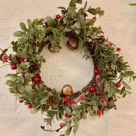 Sure to bring a traditional touch to your Christmas Decor, a round green foliage wreath with added berries and bells 