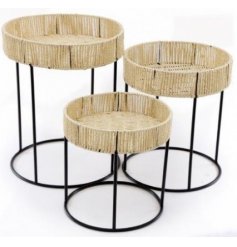 Assorted by their alternate sizes, these simple themed geometric wire based tables each feature a woven straw top 