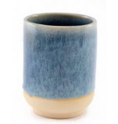 A decorative ceramic vase featuring a reactive blue glazing and natural toned base 