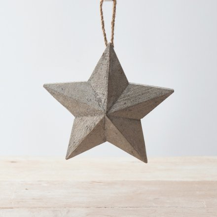 A small hanging wooden star with a rustic charm and distressed finish 