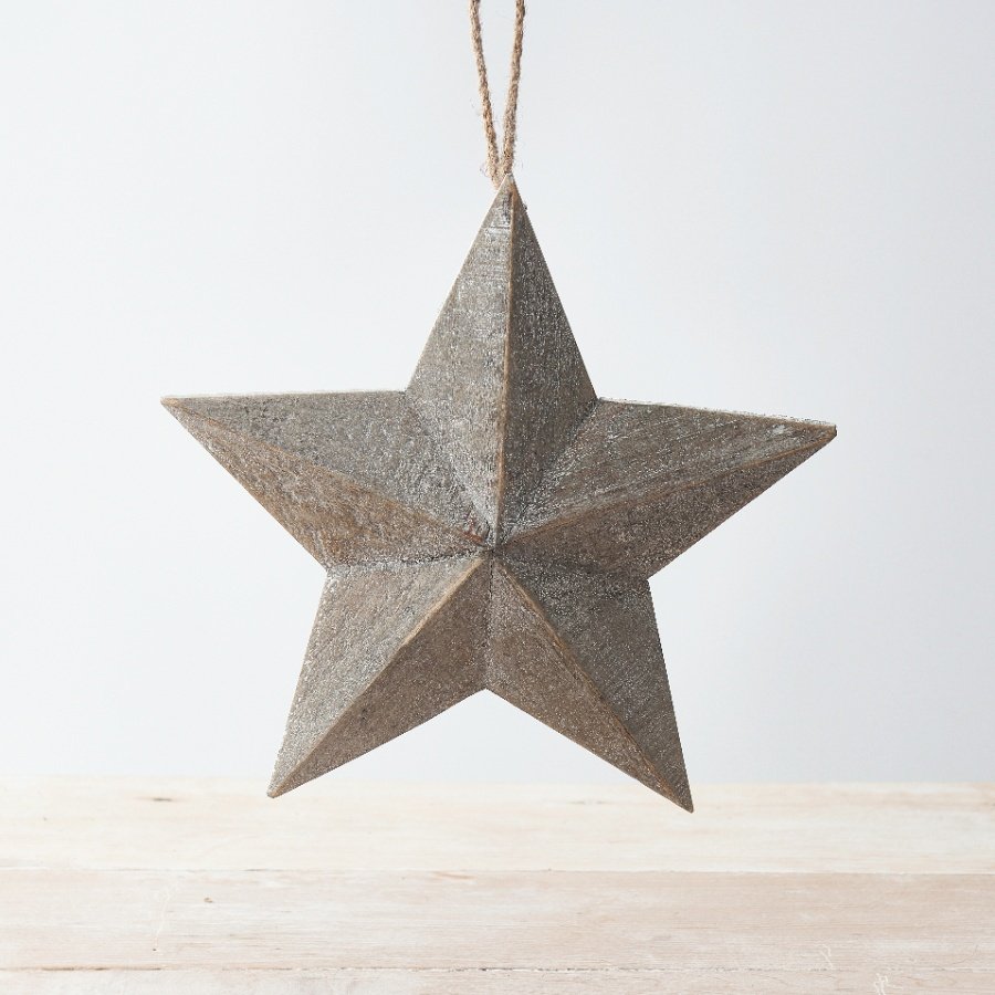A hanging wooden barn star set with a rustic finish and added chunky rope hanger 