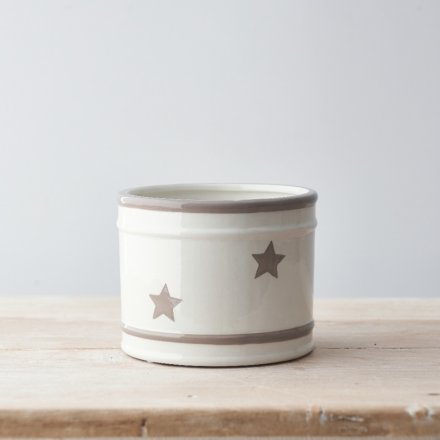 a simple ceramic pot with grey ridged edges and a faded star print 