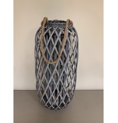   Perfect for adding a Rustic Charm to your living space, a tall standing wooden lantern with a lattice pattern and chun