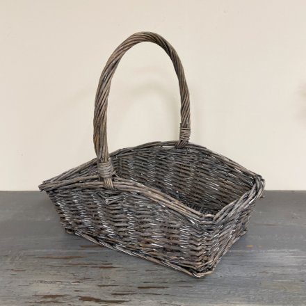 A high quality woven wicker picnic basket set with a tall traditional woven handle and rustic finish 
