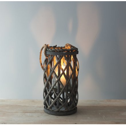  Perfect for adding a Rustic Charm to your living space, a tall standing wooden lantern with a lattice pattern and chunk
