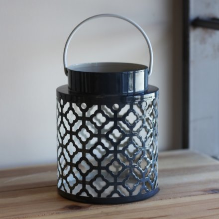  Sure to bring a modern and trendy touch to your home decor, a navy and white toned lantern with a Gatsby inspired cut d