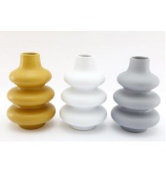 An assortment of block coloured vases in a ribbed shapes