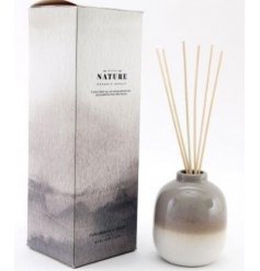  A gorgeously toned ombre diffuser bottle filled with a lusciously scented oil liquid 