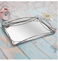 A gorgeously sleek and simple rectangular metal tray featuring a Gatsby inspired edging and mirrored centre 