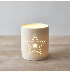  A small and simple ceramic candle pot decorated with a dotted star motif 