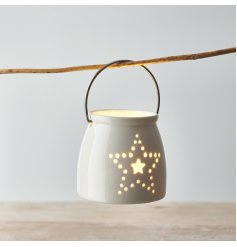  A small and simple ceramic T-light holder decorated with a dotted star motif 