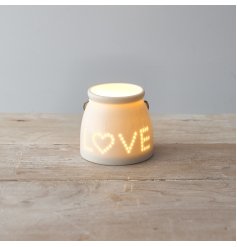 A small ceramic tlight featuring a sleek white tone and pierced dotted LOVE text decal to the front 