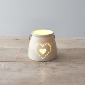 A small ceramic T-light featuring a sleek white tone and pierced dotted heart decal to the front 