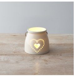 A small ceramic T-light featuring a sleek white tone and pierced dotted heart decal to the front 