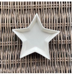 A small ceramic star shaped trinket dish, perfect for placing in any home space needing to keep trinkets safe 