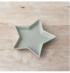 A ceramic star shaped dish featuring a smooth grey glaze finish 