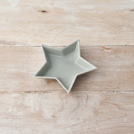 A ceramic star shaped dish featuring a smooth grey glaze finish 