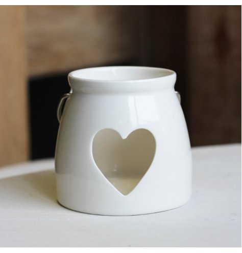 A Small tlight holder with a heart cut decal 