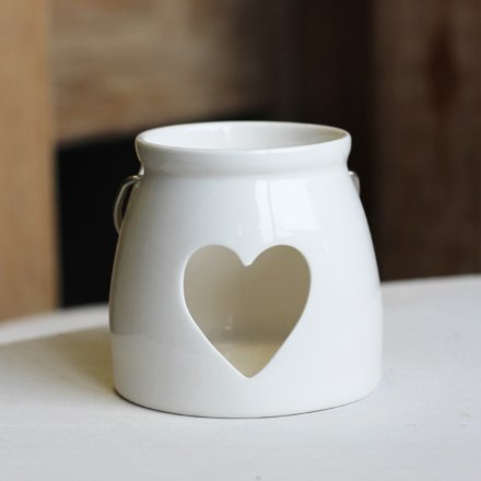 A Small tlight holder with a heart cut decal 