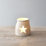 A Small tlight holder with a star cut decal 