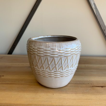 An off- white toned ceramic pot featuring a woven inspired embossed decal to complete it 