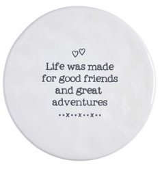 A round ceramic coaster, perfectly set with a printed text decal on top 