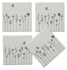 this assortment of white ceramic coasters are perfect accessories to bring to any home 