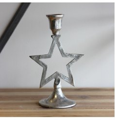 A metal based candelabra with a star decal finished with a rough texture finish 