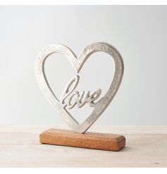 Set upon a natural wood block base, this heart ornament is perfect for bringing to any home space