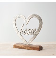 A chic and simple decorative metal heart set upon a wood base 