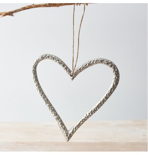 A luxurious silver metal heart decoration with a textured surface and jute string hanger.