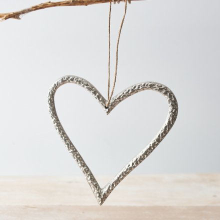 A chic silver metal heart decoration. Beautifully detailed with a hammered finish and complete with a jute string hanger