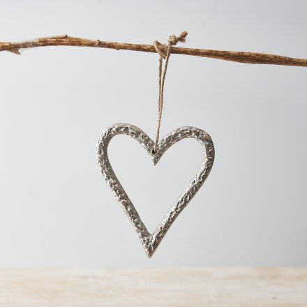 A silver metal heart decoration, complete with a jute string hanger.