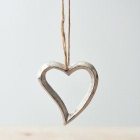 A luxe silver hanging heart decoration made from metal. Complete with a jute string hanger.