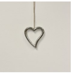 A fine quality silver hanging heart with a curved tail and textured finish. Complete with a jute string hanger.