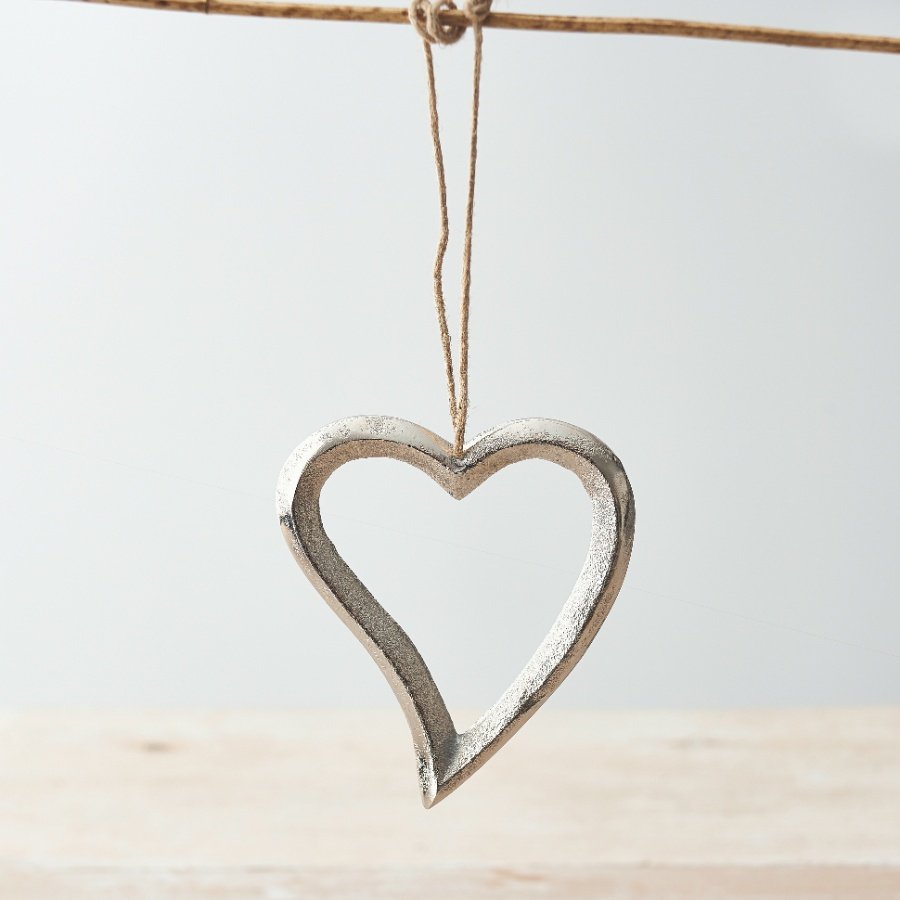 A fine quality silver hanging heart with a curved tail and textured finish. Complete with a jute string hanger.