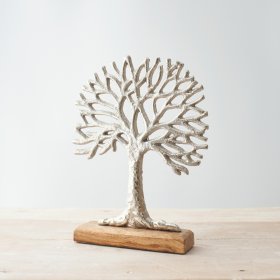  A large ornamental silvered tree decoration placed on top a natural wooden block 